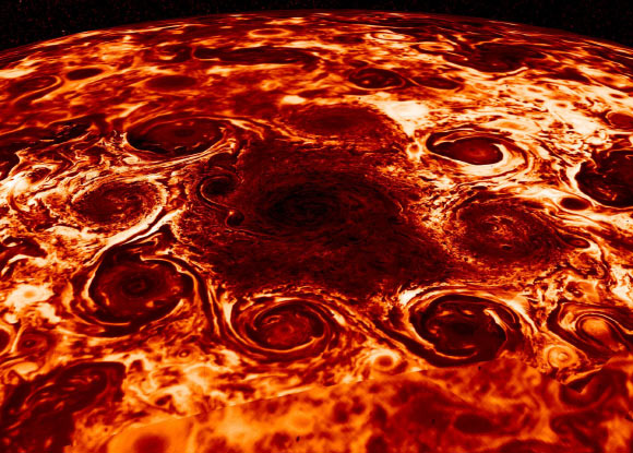 This composite image, derived from data collected by the JIRAM instrument aboard NASA’s Juno orbiter, shows the central cyclone at Jupiter’s north pole and the eight cyclones that encircle it. JIRAM collects data in infrared, and the colors in this composite represent radiant heat: the yellow (thinner) clouds are about 9 degrees Fahrenheit (minus 13 degrees Celsius) in brightness temperature and the dark red (thickest) are around minus 181 degrees Fahrenheit (83 degrees Celsius). Image credit: NASA / JPL-Caltech / SwRI / ASI / INAF / JIRAM.