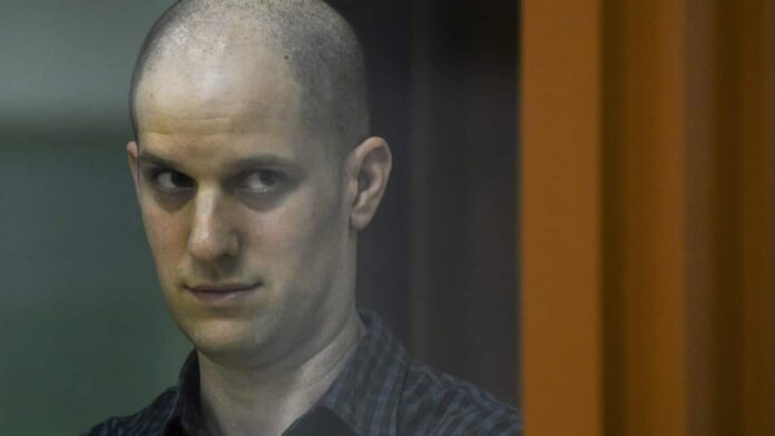 Wall Street Journal reporter Evan Gershkovich stands in a glass cage in a courtroom in Yekaterinburg, Russia.
